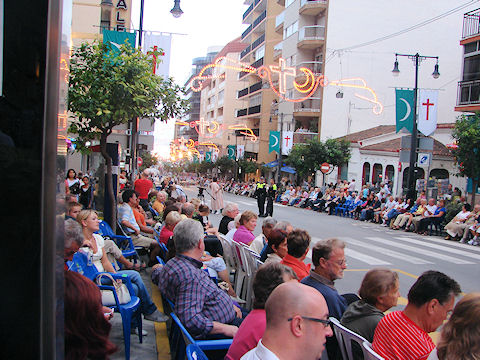 Tourists and locals alike line the Calpe streets for another festival parade